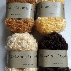 May include: Four skeins of yarn in different shades: caramel, honey, natural blonde, and brunette. Each skein is labelled "Wild Large Loop Mohair" and "Little Oake Dolls".