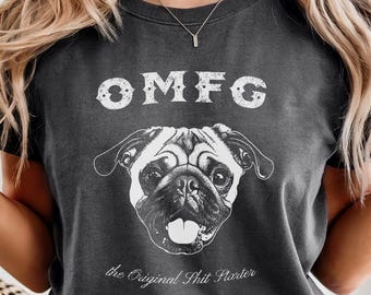 May include: A charcoal grey crew neck t-shirt featuring a white graphic of a pug dog face. Above the dog is the text OMFG in a distressed font, and below the dog is the text the Original Shit Starter in a white cursive script font.