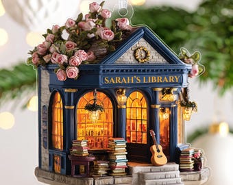 May include: A detailed Christmas tree ornament depicting a library, with the text "SARAH'S LIBRARY" above the arched windows. The ornament includes a guitar, books, and a red and white gingham bow, with a ribbon for hanging.