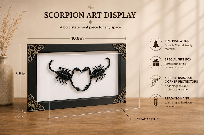 May include: A black rectangular frame containing two black scorpions arranged in a heart shape on a white background. The frame features ornate brass corner protectors and a clear acrylic front. Dimensions are 10.6 inches wide, 5.5 inches high, and 1.2 inches deep.