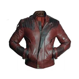 May include: A burgundy leather jacket with black detailing. The jacket has a zip-up front, multiple pockets, and ribbed detailing on the sleeves. The shoulders have a padded design, and the collar is a stand-up style.