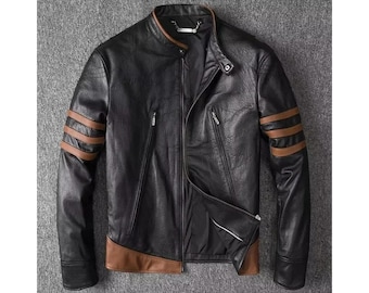 May include: Black leather jacket with brown accents. The jacket features a stand-up collar, a zipper closure, and brown stripes on the sleeves. The jacket has two zippered pockets on the chest and brown trim at the bottom.