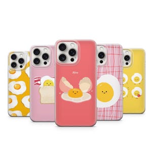 May include: Five different iPhone cases with a variety of egg-themed designs. The cases are all pink, red, yellow, and white. One case features a fried egg with a smiling face and the text "Alive".