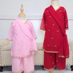 May include: A rustic wooden sign with the text "Welcome to our home" in white lettering. The sign features a distressed finish and a simple, inviting design, perfect for front door decor.