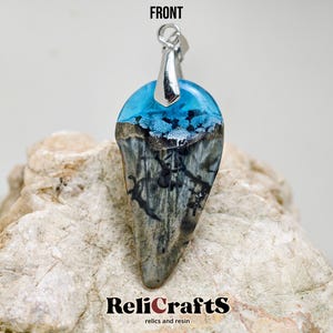 Fossilized shark tooth with resin (clear blue/white)