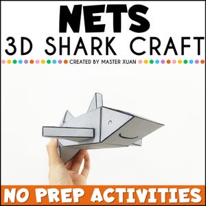 Puede incluir: Un tiburón de papel 3D con una cara sonriente. El tiburón es gris con contornos negros y se sostiene en una mano. El texto "NETS 3D SHARK CRAFT" está en la parte superior de la imagen y el texto "NO PREP ACTIVITIES" está en la parte inferior de la imagen.