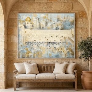 May include: An abstract painting of a religious site with a golden dome, set in a white frame. The artwork hangs above a wooden bench with beige cushions. The scene is set in an outdoor space with stone walls and arched doorways.