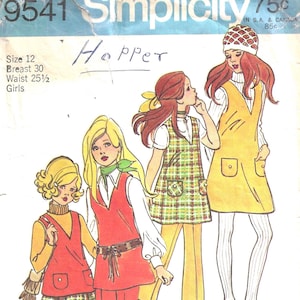 May include: A vintage Simplicity sewing pattern with illustrations of girls in 1970s outfits. The designs include a red vest and trousers ensemble, a plaid jumper, and a yellow jumper dress. The pattern is labelled "Hopper" and includes size information.