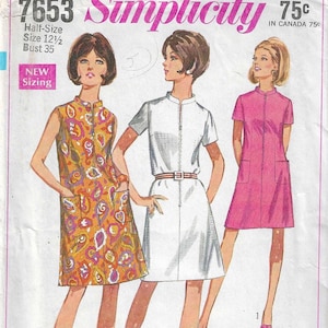May include: Simplicity sewing pattern number 7653 for a sleeveless dress with a zipper closure, a white dress with short sleeves and a zipper closure, and a pink dress with short sleeves and a zipper closure. The pattern is for half-sizes 12 1/2 and bust size 35. The pattern is labeled "easy cut, easy sew" and "Jiffy 3 or 4 main pattern pieces".