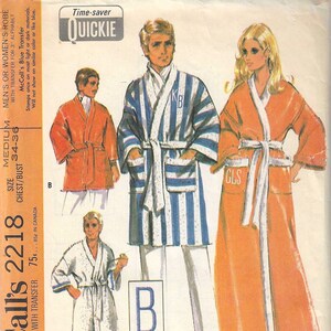 May include: A sewing pattern for a robe with a blue and white striped design, an orange robe, and a white robe. The pattern includes a transfer sheet for adding initials to the robes. The pattern is for sizes 34-36.