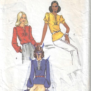 May include: Vintage Butterick sewing pattern featuring three blouse designs. The pattern includes a size 10 with a 32 1/2 inch bust. The cover art shows illustrations of the blouses in red, yellow, and blue, with the text "Butterick THE FASHION ONE".