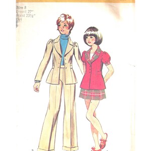 May include: Simplicity sewing pattern 5822 featuring two girls' outfits. One outfit includes a beige suit with a peplum jacket and wide-leg pants. The other outfit is a red jacket with a plaid skirt. The pattern is size 8, with a 27" bust and 23.5" waist.