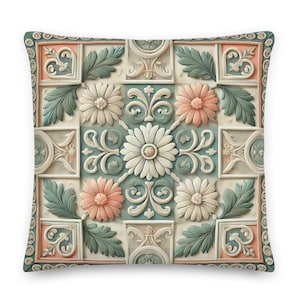 Puede incluir: Una almohada cuadrada con un patrón floral decorativo. La almohada presenta un diseño repetitivo de flores y hojas estilizadas en tonos melocotón, blanco y verde.