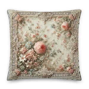 Puede incluir: Una almohada cuadrada con un diseño floral. La almohada presenta un fondo blanco con un delicado borde de encaje. El diseño floral está en tonos de rosa, blanco y verde. La almohada es perfecta para agregar un toque de elegancia a cualquier habitación.