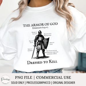May include: White long-sleeve sweatshirt with a black and white illustration of a knight in armor. The text "THE ARMOR OF GOD" is above the illustration, and the text "DRESSED TO KILL" is below the illustration. The text "EPHESIANS 6:13-17" is in smaller font below the title.