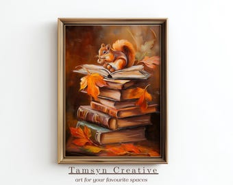 May include: A framed painting depicts a stack of books with a squirrel perched on top, eating. Autumn leaves are scattered around the books. The artwork has a warm color palette of browns, oranges, and greens. The text "Tamsyn Creative" is at the bottom.
