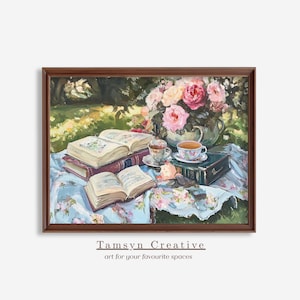 May include: A framed painting depicts a serene outdoor scene. Open books, teacups, and a vase of pink roses rest on a floral tablecloth. The artwork is signed "Tamsyn Creative" with the tagline "art for your favourite spaces".