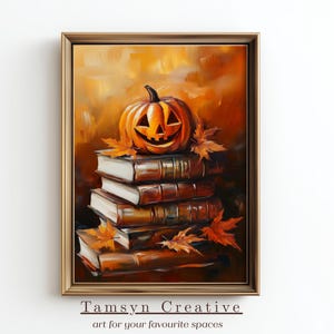 May include: A framed painting shows a carved orange pumpkin with a smiling face on top of a stack of books. Autumn leaves are scattered around the books. The artwork has a warm colour palette, ideal for autumn decor.