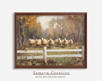 May include: A framed print of a pastoral scene featuring a flock of sheep behind a white fence. The artwork has a warm color palette with autumn foliage and a brown wooden frame. The text "Tamsyn Creative" is at the bottom.