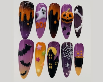 May include: A set of ten long, almond-shaped press-on nails with a Halloween theme. Designs include a ghost with "BOO" text, a pumpkin, bats, stars, a haunted house, a spider web, and a bubbling cauldron, all in shades of purple, orange, and black.