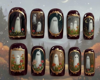 May include: Set of ten burgundy press-on nails with a gold trim. Each nail features a miniature painting of a ghost in a frame, with mushrooms and a forest background. The artwork has a whimsical, Halloween theme.