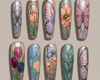 May include: A collection of ten decorative nail art designs. Each design features a different floral or butterfly motif, with iridescent and stained-glass effects. The color palette includes pinks, purples, blues, and greens, with gold-colored borders.