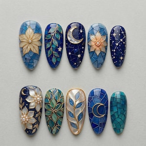 May include: Ten intricately designed nail art samples are displayed. Each nail showcases a unique design, including floral patterns, celestial motifs with moons and stars, and mosaic-style backgrounds. The colour palette includes blues, greens, and gold accents.