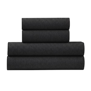May include: A stack of four folded dark gray bed sheets. The sheets are made of a soft, textured material and are neatly arranged. The image is a close-up shot of the folded sheets, showcasing their color and texture.