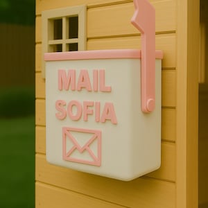 May include: A cream-colored mailbox with pink accents and the name "MAIL SOFIA" in pink letters. The mailbox is mounted on a yellow wooden structure and features a pink envelope symbol.