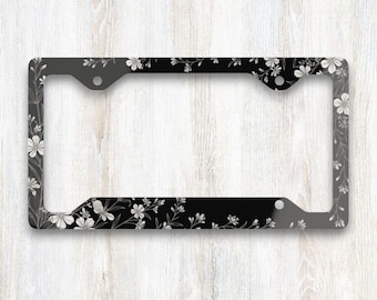 Cadre de plaque d'immatriculation Midnight Botanical Corner Garden, motif floral noir et blanc, accessoire élégant pour voiture inspiré des fleurs sauvages.