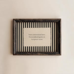 May include: A framed print with a black and white striped background and a cream-coloured, scalloped-edge insert. The insert features the text: "Your custom text here. Personalized quote or Scripture verse."
