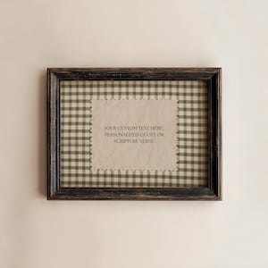 May include: A framed artwork with a distressed black wooden frame. The artwork features a gingham pattern background with a textured, light-colored paper in the center. The paper contains the text: "YOUR CUSTOM TEXT HERE. PERSONALIZED QUOTE OR SCRIPTURE VERSE."