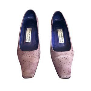 May include: A pair of light brown, square-toe pumps with small, dark brown polka dots. The shoes have a low heel and a blue interior. The brand name "BALENCIAGA PARIS El Corte Ingles" is printed inside each shoe.
