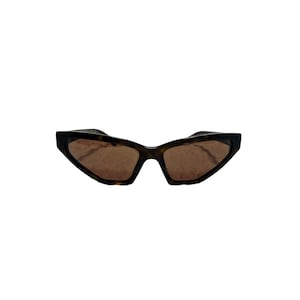 May include: Angular sunglasses with a tortoiseshell pattern frame and brown lenses. The sunglasses have a unique, geometric shape, with a narrow bridge and angled edges. The lenses are a warm brown color, providing a contrast to the darker frame.