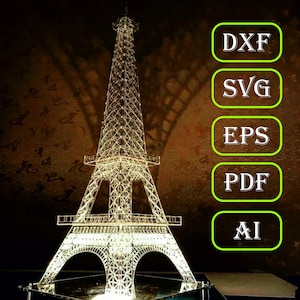 May include: A clear acrylic model of the Eiffel Tower with a light inside, illuminated against a dark background. The image includes text labels for different file formats: DXF, SVG, EPS, PDF, and AI.