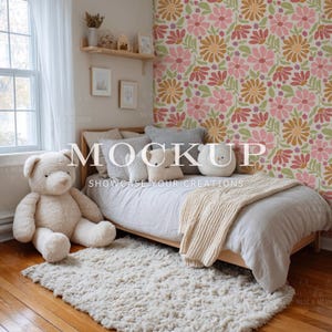 May include: A cozy bedroom scene featuring a wooden bed with gray bedding, pillows, and a cream-colored throw blanket. A large teddy bear sits on the floor next to a shaggy rug. The wall has a floral pattern and the text "MOCKUP SHOWCASE YOUR CREATIONS".