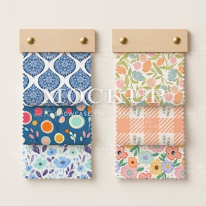 May include: Two wooden display boards with fabric swatches. The swatches display floral, geometric, and abstract patterns in blue, orange, and pink. The text "MOCKUP" and "SHOWCASE YOUR CREATIONS" is visible.