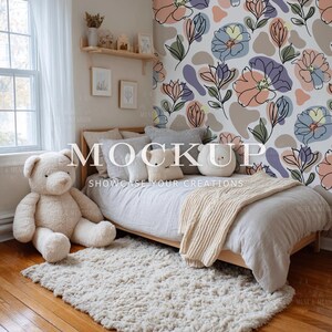 May include: A cozy bedroom scene featuring a light wood bed with a cream-colored blanket and pillows. A large teddy bear sits on the floor next to a fluffy rug. The wall has a floral pattern, and the text "MOCKUP" is visible.