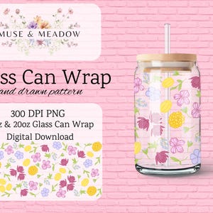 May include: A clear glass can wrap with a floral design featuring pink, purple, yellow, and blue flowers. The glass has a wooden lid and a clear straw. The image also includes text that reads "Muse & Meadow" and "Glass Can Wrap".
