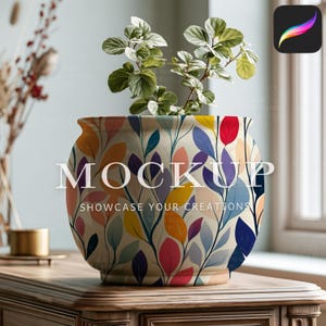 May include: A round ceramic planter featuring a colorful botanical pattern of leaves in shades of red, yellow, blue, and purple on a cream background. The planter contains a small green plant and displays the text MOCKUP SHOWCASE YOUR CREATIONS.