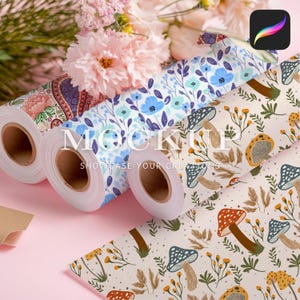 May include: Three rolls of wrapping paper with different patterns. The first roll has a paisley design in shades of blue, green, and pink. The second roll has a floral pattern with blue flowers on a white background. The third roll has a mushroom and floral pattern in shades of brown, yellow, and white. The text "MOCKUP SHOWCASE YOUR CREATIONS" is printed on the rolls.