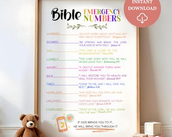May include: A framed print titled "Bible Emergency Numbers" with a pink download icon. The print lists Bible verses for various emotions like worry, fear, and sadness. A teddy bear sits in front of the print.