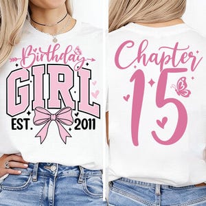 May include: White t-shirt with pink text and graphics. The front features "Birthday GIRL" with a bow, and "EST. 2011". The back says "Chapter 15" with a butterfly and hearts. A casual, celebratory design.
