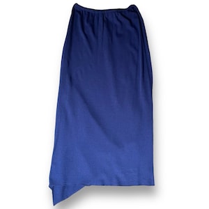 May include: A navy blue skirt with an elastic waistband and a slightly asymmetrical hemline. The skirt is made of a soft, flowing fabric and is suitable for various occasions.