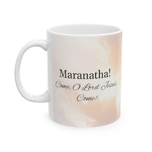 May include: White ceramic coffee mug with a light pink and orange cloudy sky background. The mug has black text that reads "Maranatha! Come, O Lord Jesus, Come!"