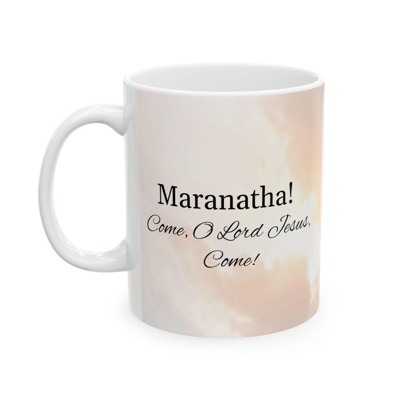 May include: White ceramic coffee mug with a light pink and orange cloudy sky background. The mug has black text that reads "Maranatha! Come, O Lord Jesus, Come!"