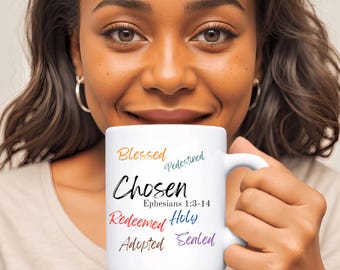 May include: White ceramic mug with the words "Blessed, Predestined, Chosen, Ephesians 1:3-14, Redeemed, Holy, Adopted, Sealed" in colorful lettering.