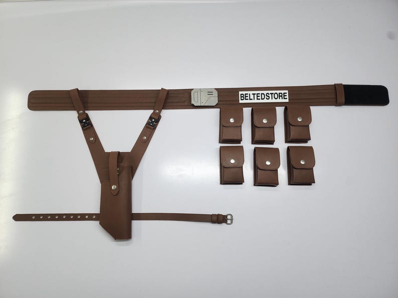 May include: A brown leather utility belt with six pouches, a holster, and suspenders. The belt has a silver buckle and a black section on the end. The text "BELTEDSTORE" is printed on the belt.