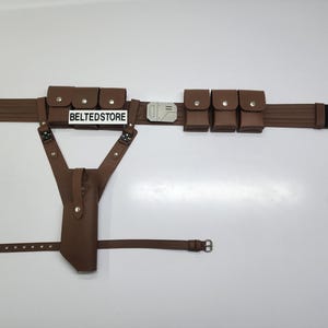 May include: A brown utility belt with multiple pouches and a holster. The belt features a rectangular buckle and a black section at the end. The text "BELTEDSTORE" is visible on a white label.