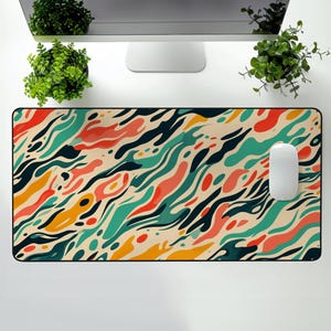 May include: A colourful abstract design mouse mat with a swirling pattern of red, orange, yellow, green, blue, and black. The mouse mat is on a white surface.